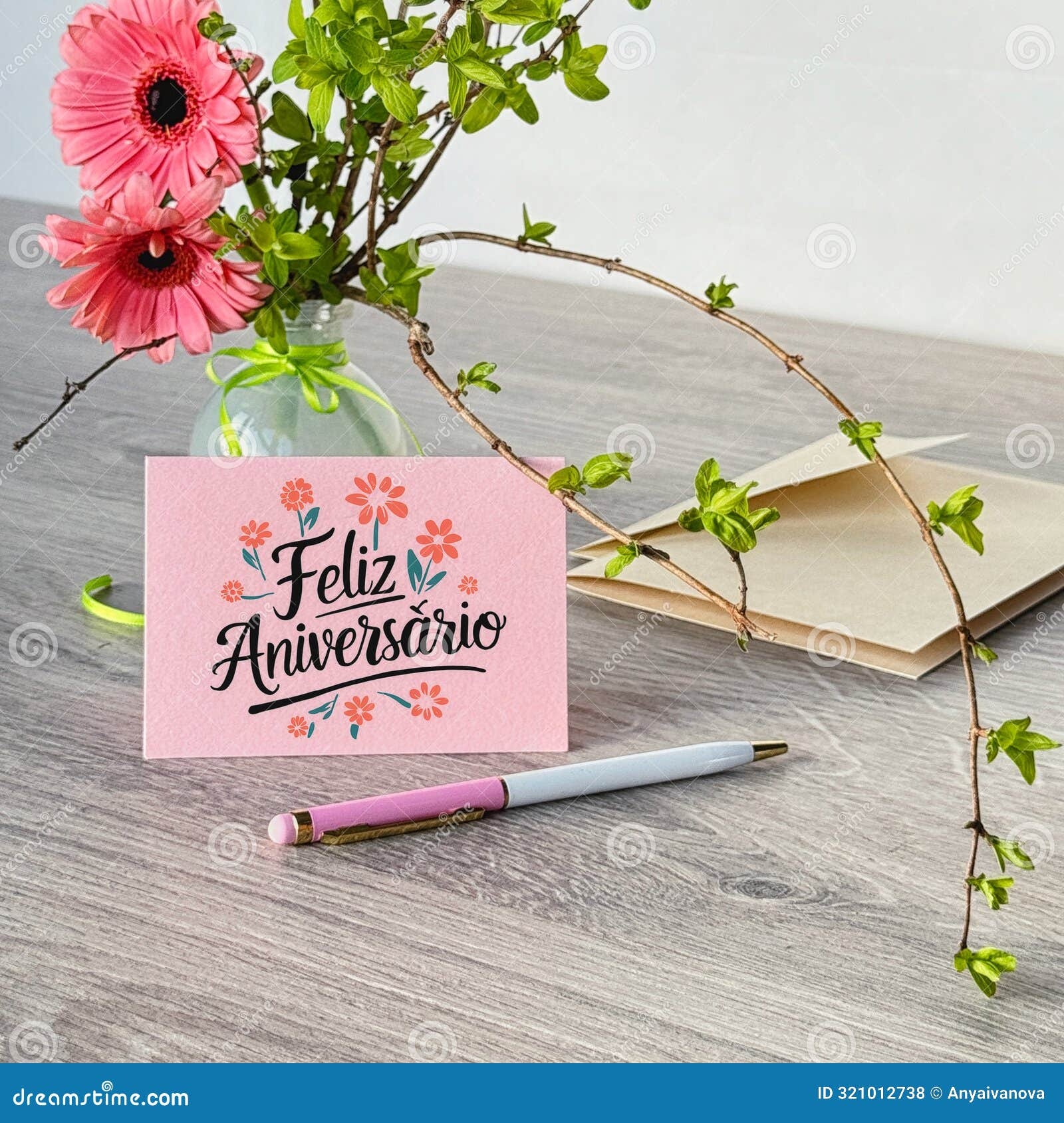Greeting Cards In Spanish Feliz Aniversario Means Happy Anniversary In Spanish Language Greeting Card With Pink Flowers Pen And Envelope On Wooden Desk 2xa8fjn Anniversary Card For Son And Daughter In Law