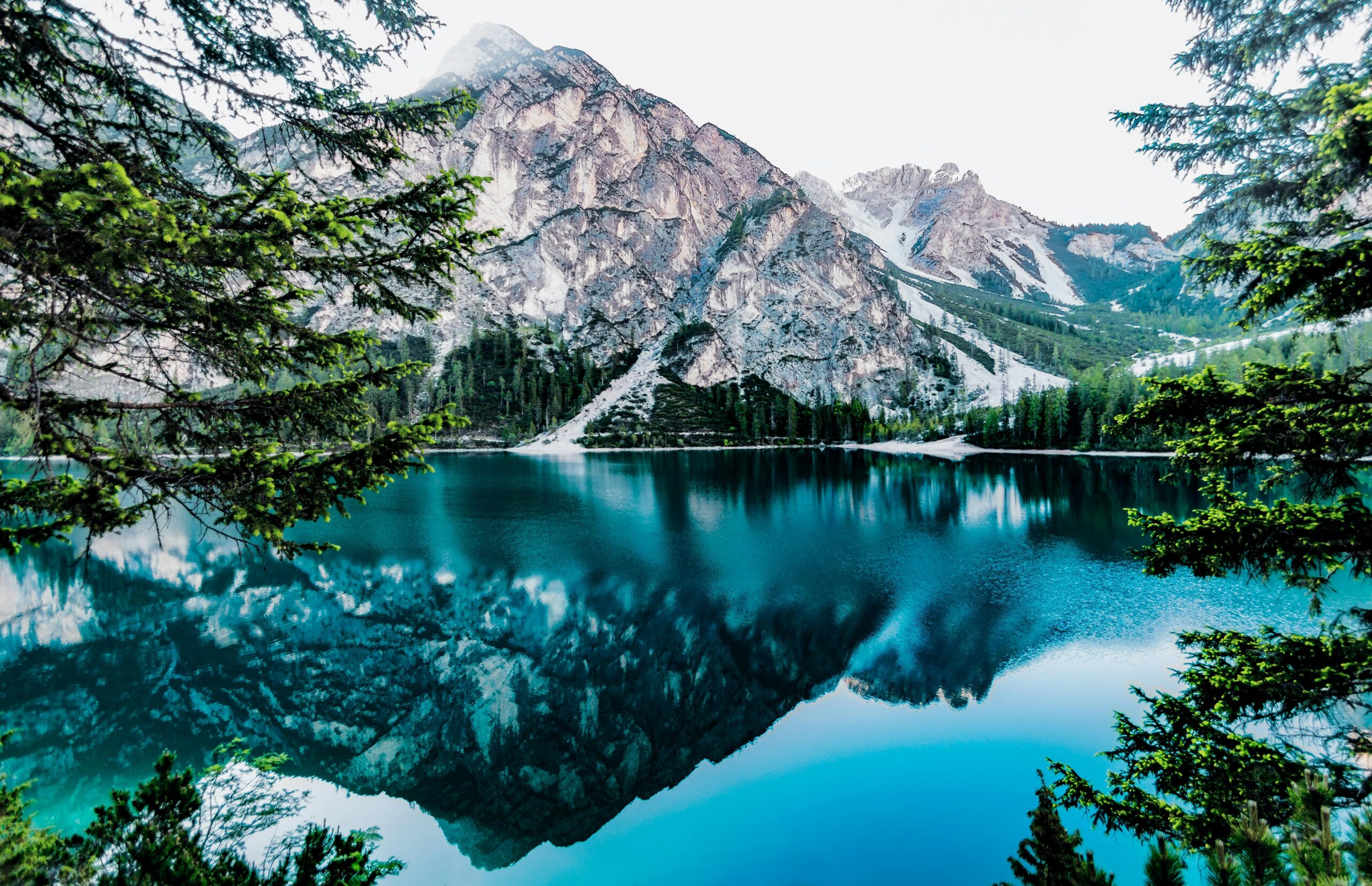 Lake And Mountain Under White Sky Free Stock Photo