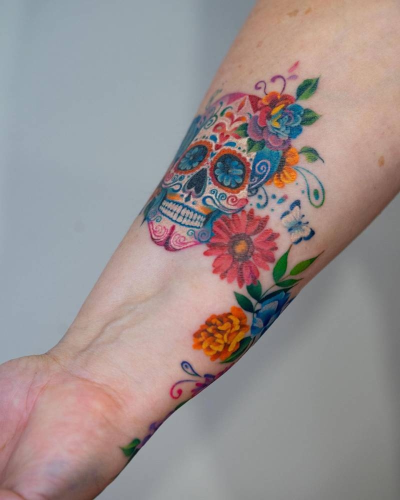 Sugar Skull And Flowers Tattooed On The Wrist 